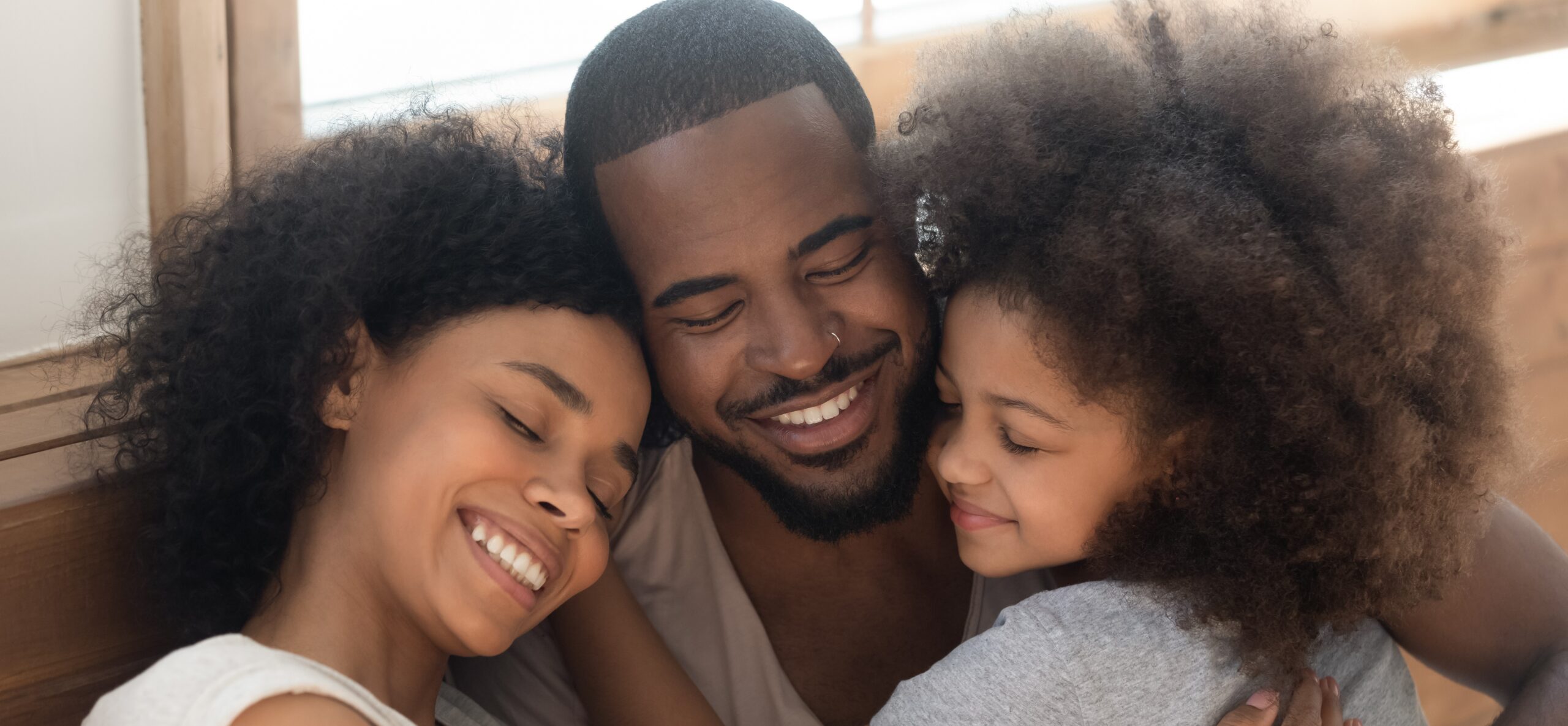 Happy,Affectionate,African,American,Family,Of,Three,Bonding,Embracing,,Cute Power of gratitude - Counseling Charlotte